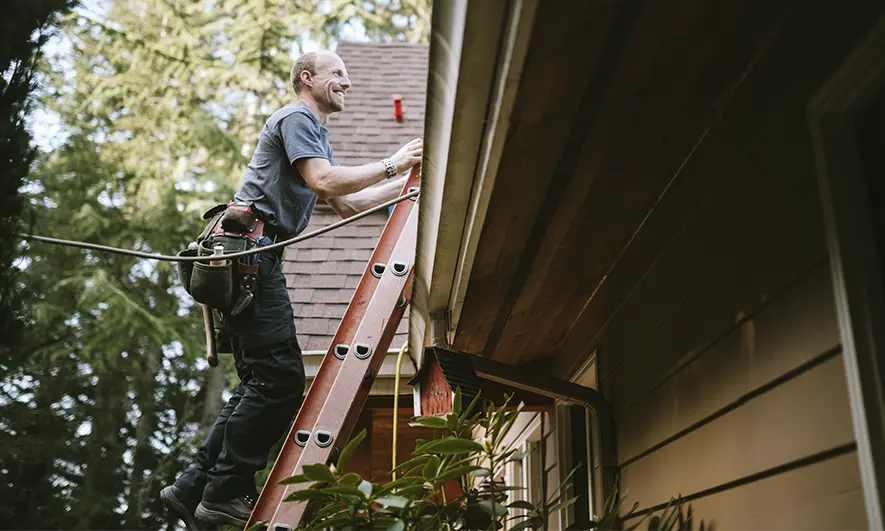 business owner happy to do his job after getting gutter cleaning insurance quote