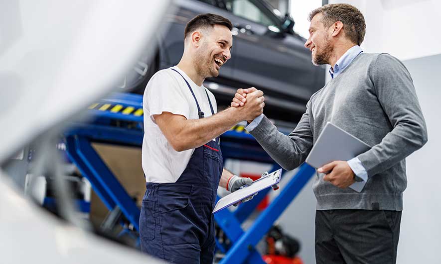small business owners celebrate having auto maintenance insurance