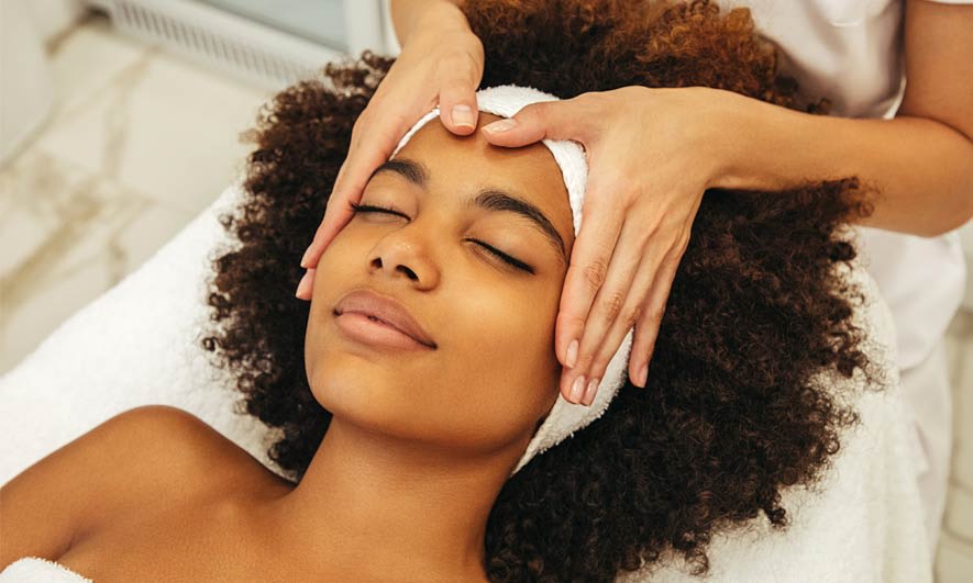 A woman getting a facial massage