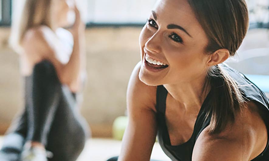 A teacher smiles knowing that she is protected by yoga studio insurance