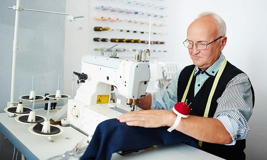 tailor sewing a piece of fabric
