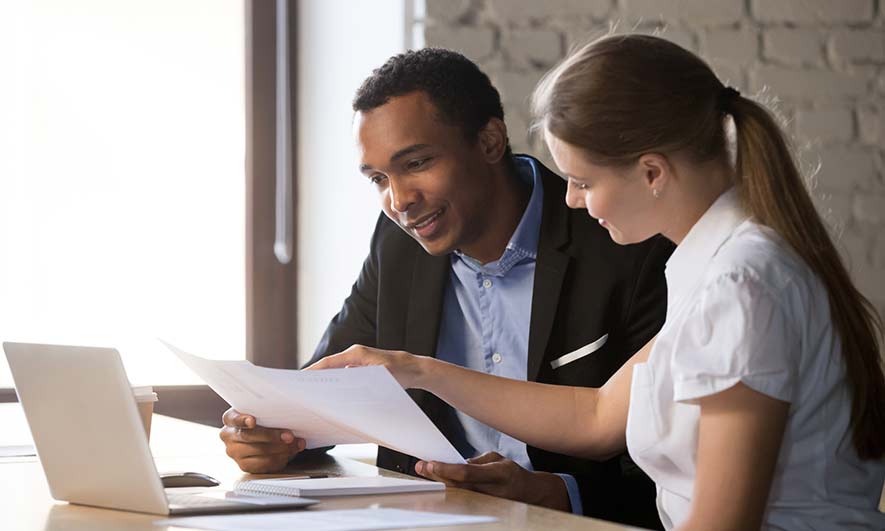 two business people looking at commercial insurance coverages