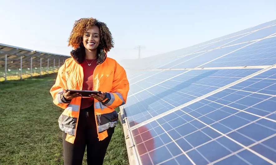Solar worker stands in a panel field