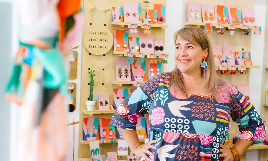 happy small business owner protected by insurance for artisans