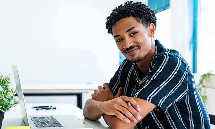 male business owner happily works after getting insurance for marketing agency quote