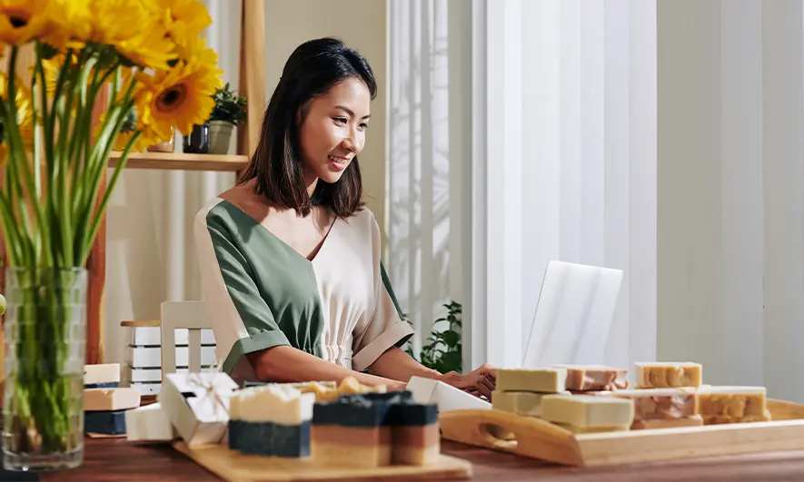 business owners happy to do her job after getting insurance for soap makers