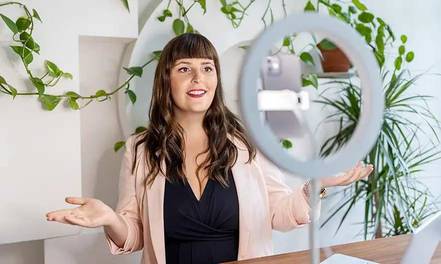 female small business owner happy to have insurance for social media