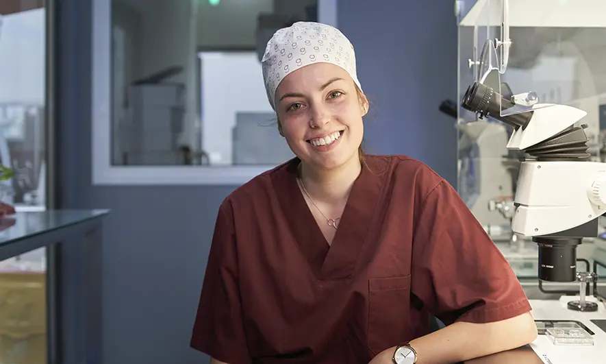 business owner happy to do her job after getting a insurance for surgeons quote