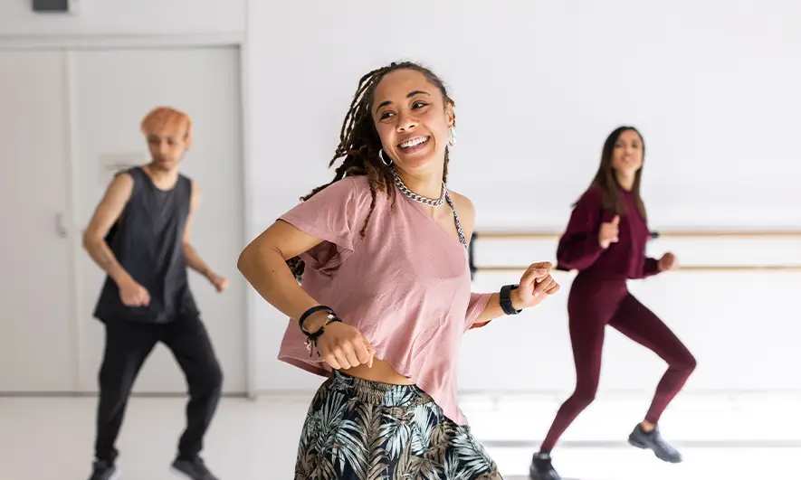 female business owner happily works after getting insurance for zumba instructors quote