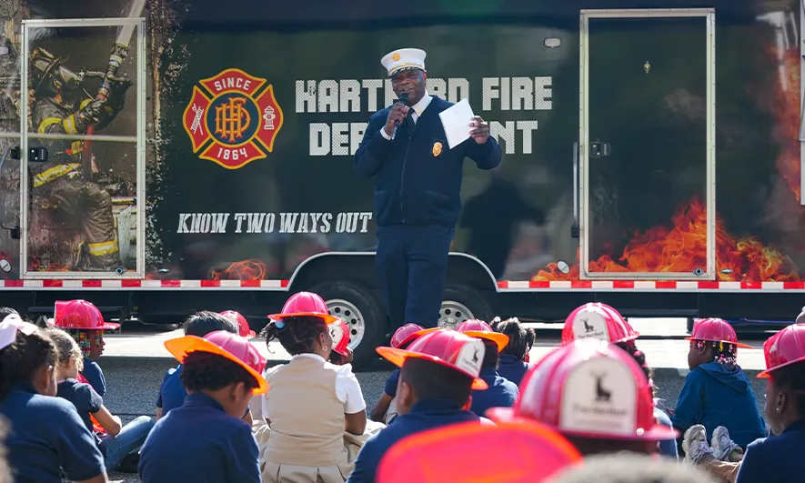 firefighter talking to children