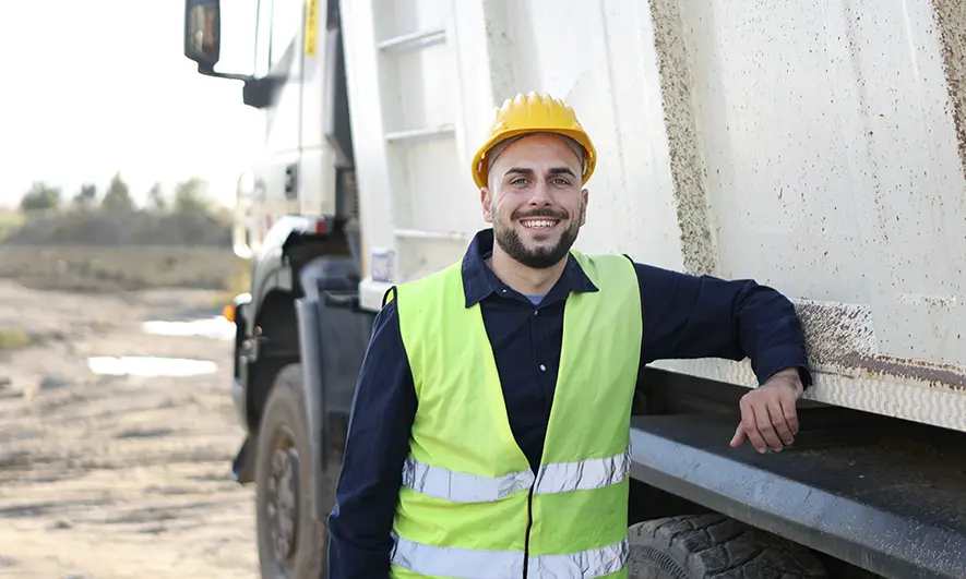 business owner happy to do his job after getting junk removal business insurance