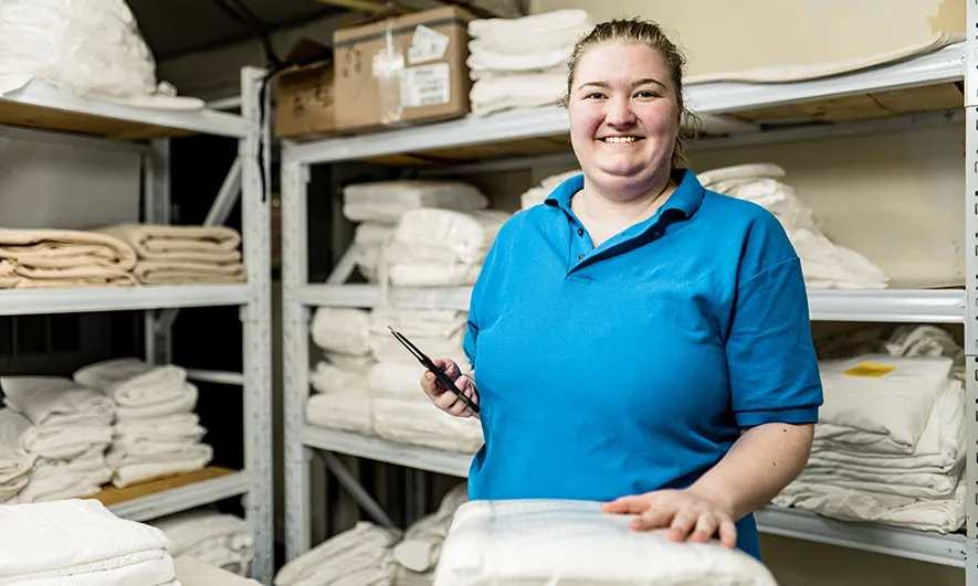 small business owner happy with laundry insurance