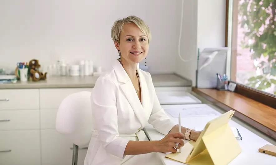 business owner happy to do her job with malpractice insurance for aesthetic nurses