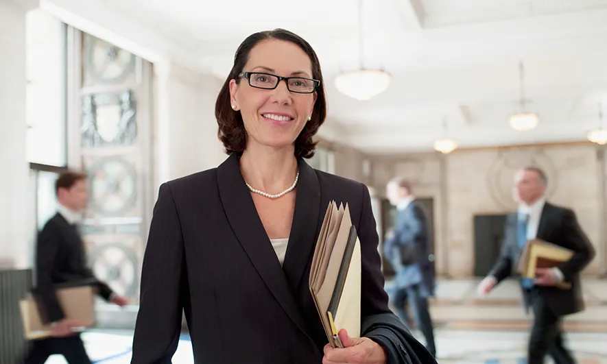 man and woman talking in front of large building