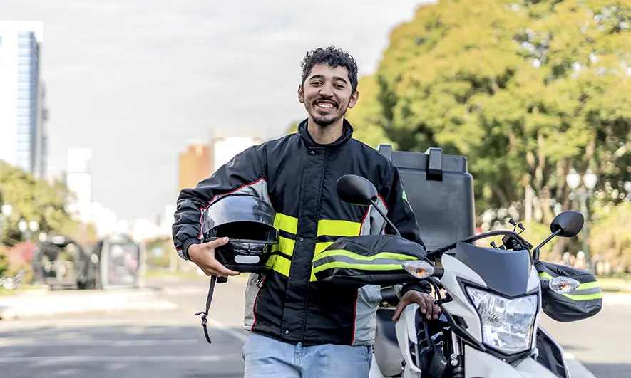 business owner happily does his job after getting motorbike courier insurance