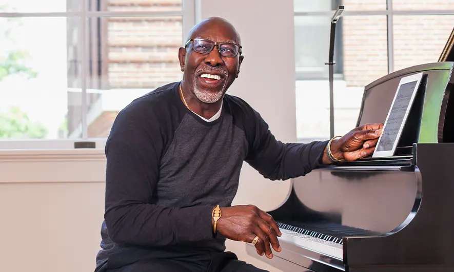 business owner happy to do his job after getting musician insurance