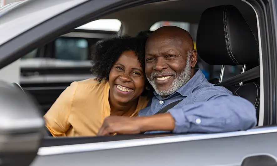 couple happy after getting new motor insurance from The Hartford