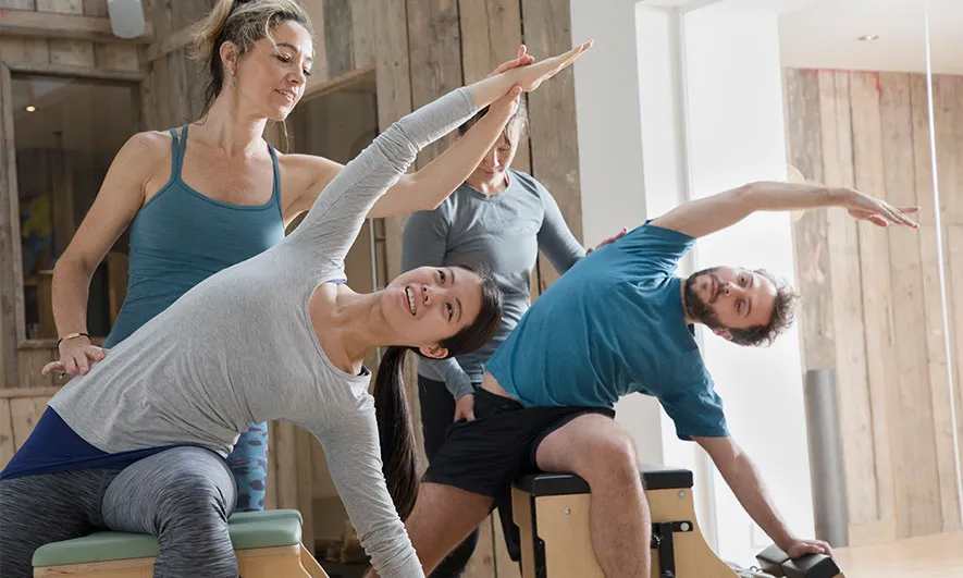 instructors smile knowing they are protected by pilates insurance