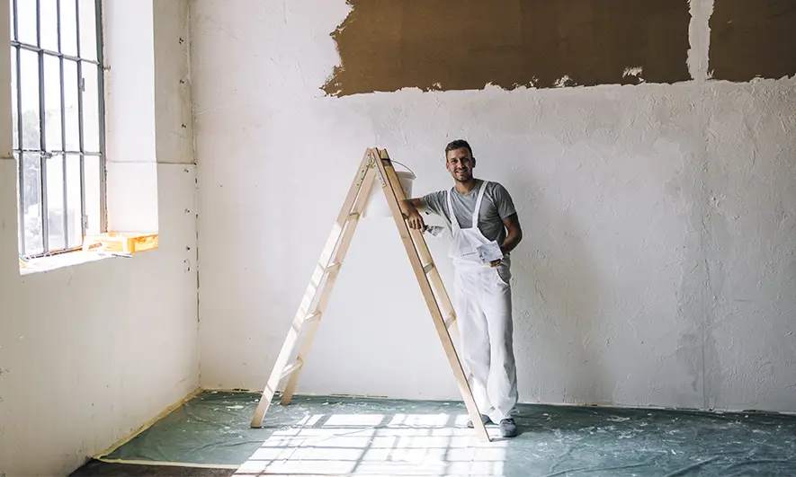 business owner happy to do his job after getting plasterer insurance