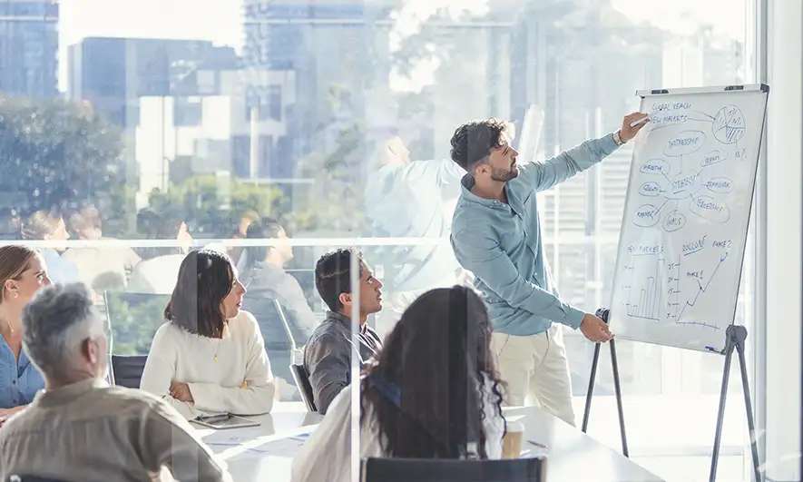 man presents at an office meeting
