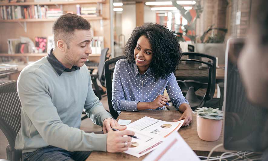 business owners discussing professional liability insurance coverage