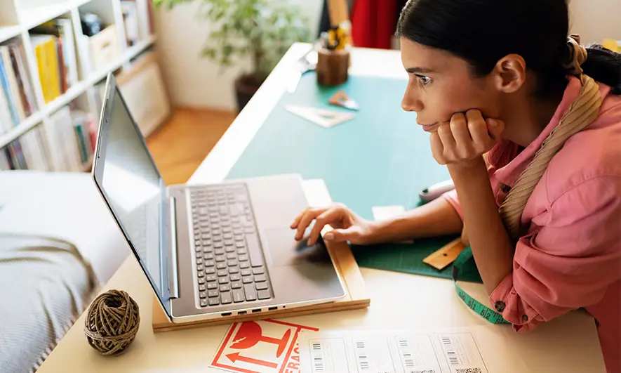 female business owner happily works after getting professional organizer insurance quote