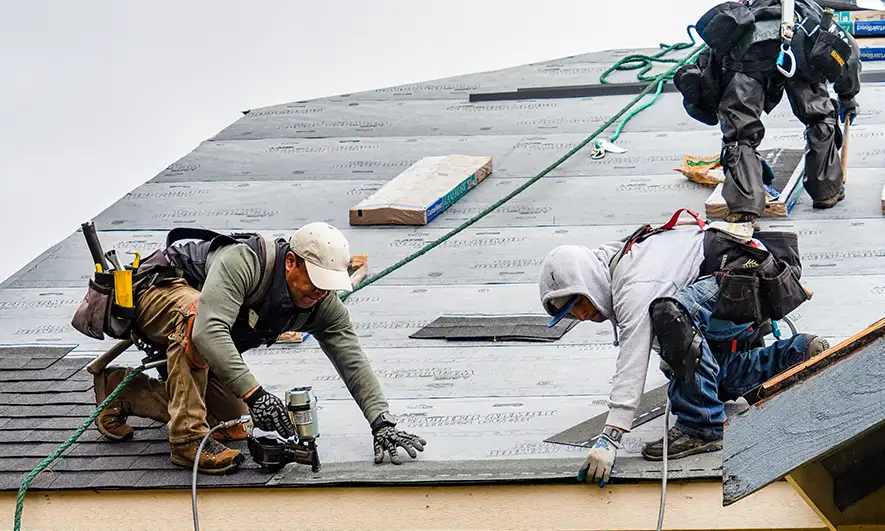 male small business workers protected by roofing business insurance