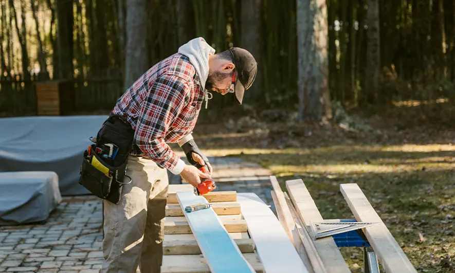 business owner happily does his job after getting a siding installation insurance quote