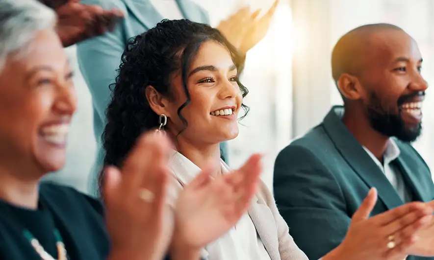 female and male business owners happily work after getting speaker insurance quote