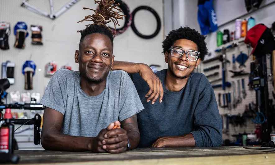 male business owners happily work after getting sporting goods store insurance quote