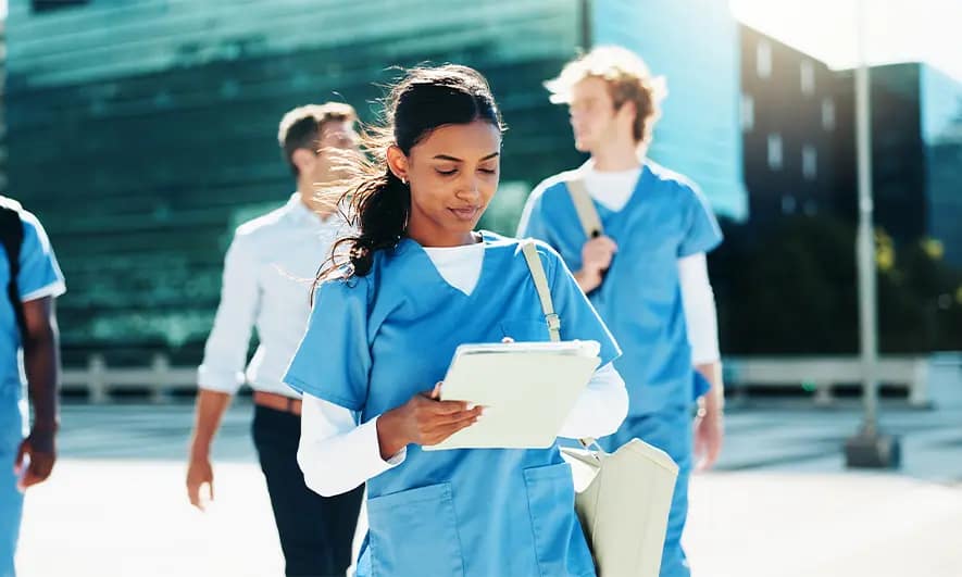 business owner happily does her job after getting a travel nurse liability insurance quote