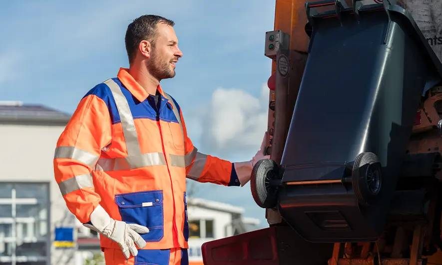 business owner happy to do his job after getting waste hauler insurance