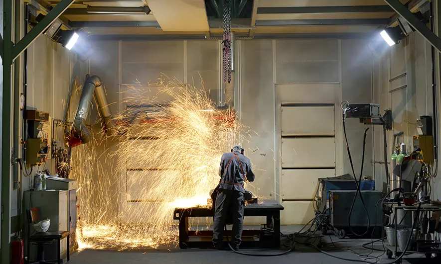 business owner happy to do his job after getting welding business insurance