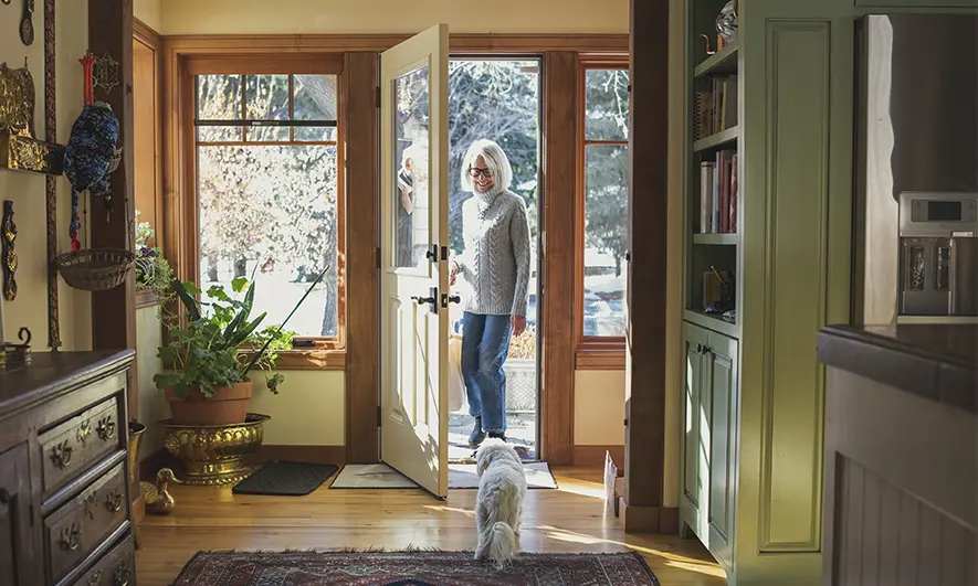 female customer happily enjoys her home due to understanding what is dwelling coverage