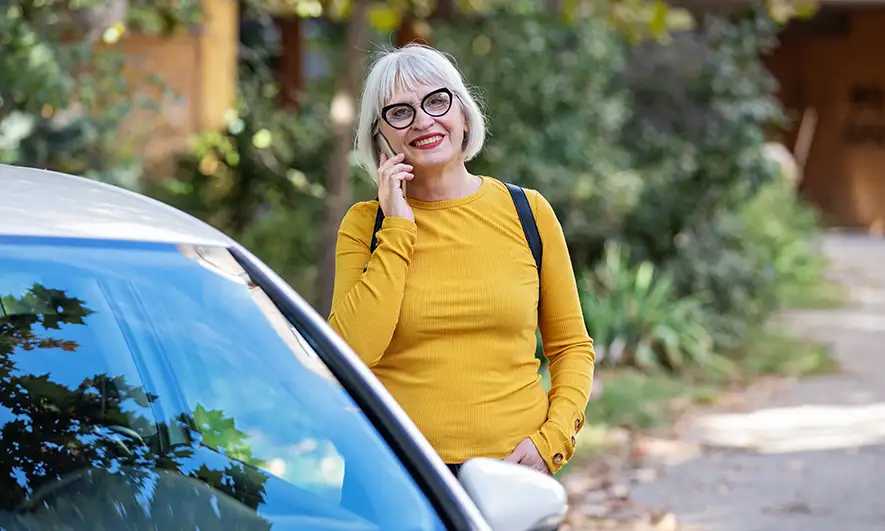 woman happy to know when will car insurance go down