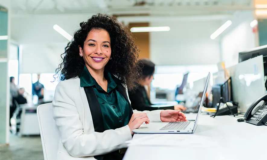 Woman smiling at an office desk