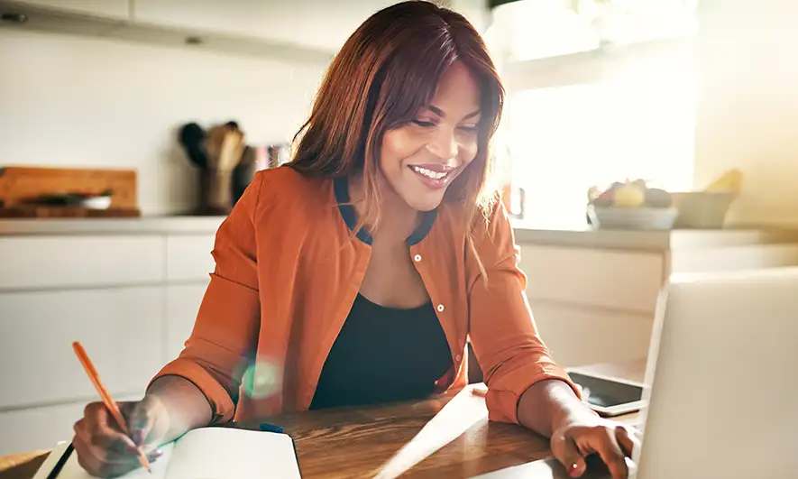 female small business owner enjoying the job understanding workers compensation for employees working from home