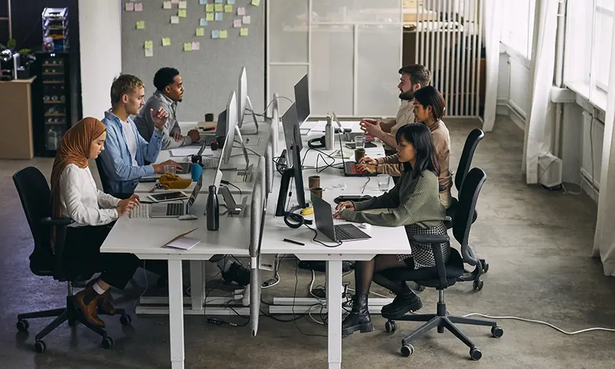people working on their computers at desks